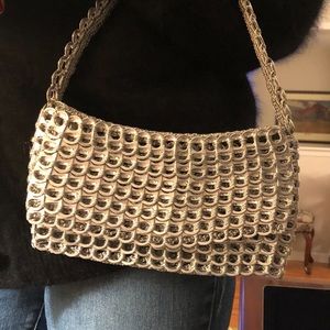 Escama Studio silver pop tab handbag.